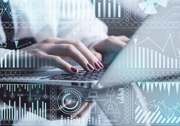 Unrecognizable businesswoman using device at workplace with digital business interface. Future and accounting concept. Double exposure